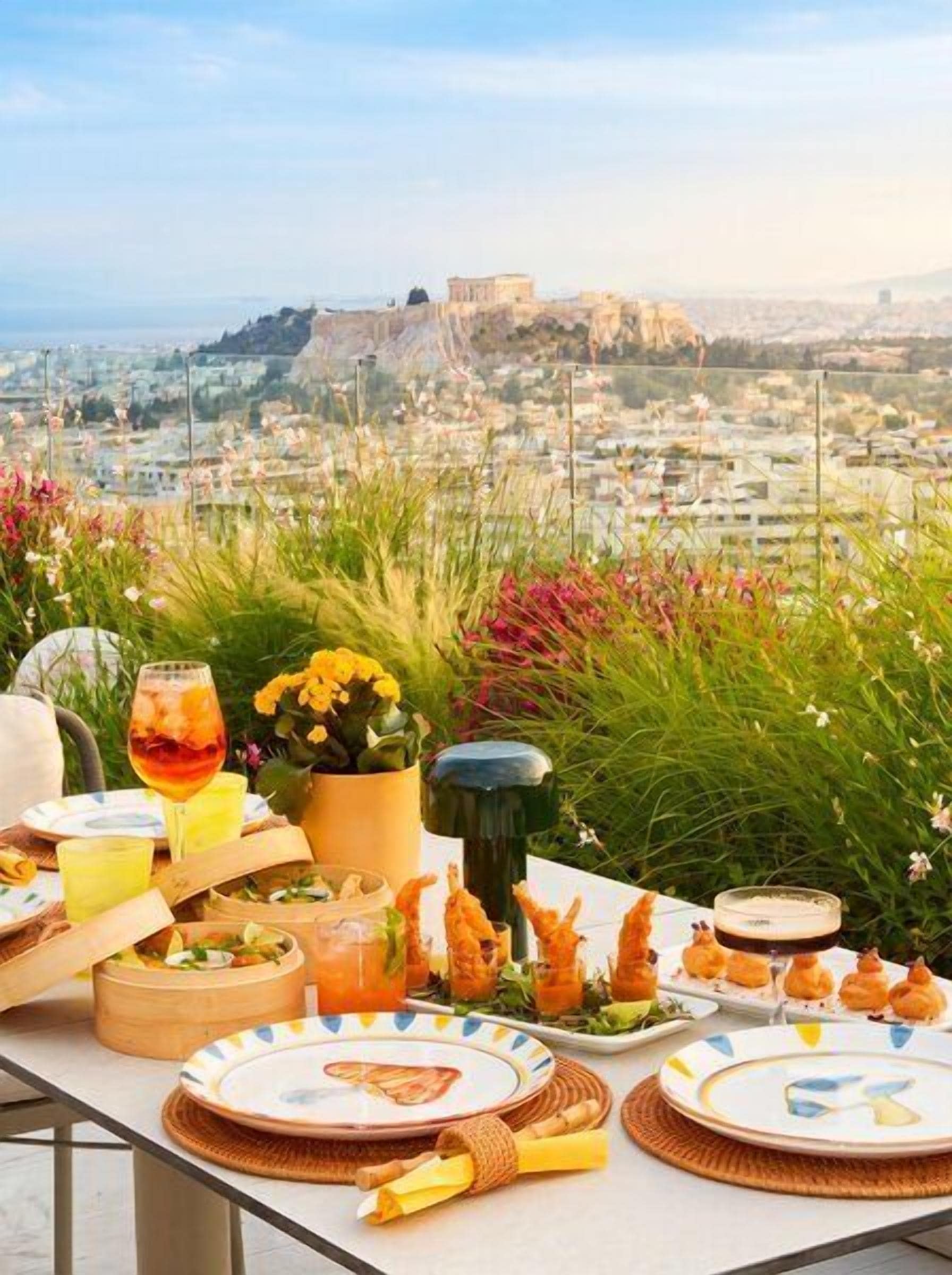 A table set for a meal with a view of a cityscape and a fort.