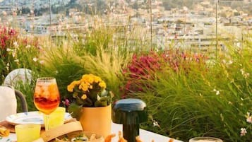 A table set for a meal with a view of a cityscape and a fort.