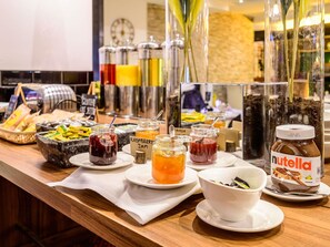 A buffet with various food items and condiments.
