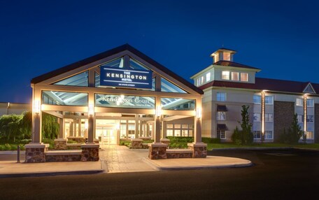 The Kensington Hotel with a prominent entrance, a covered area, and a separate building with a red roof.