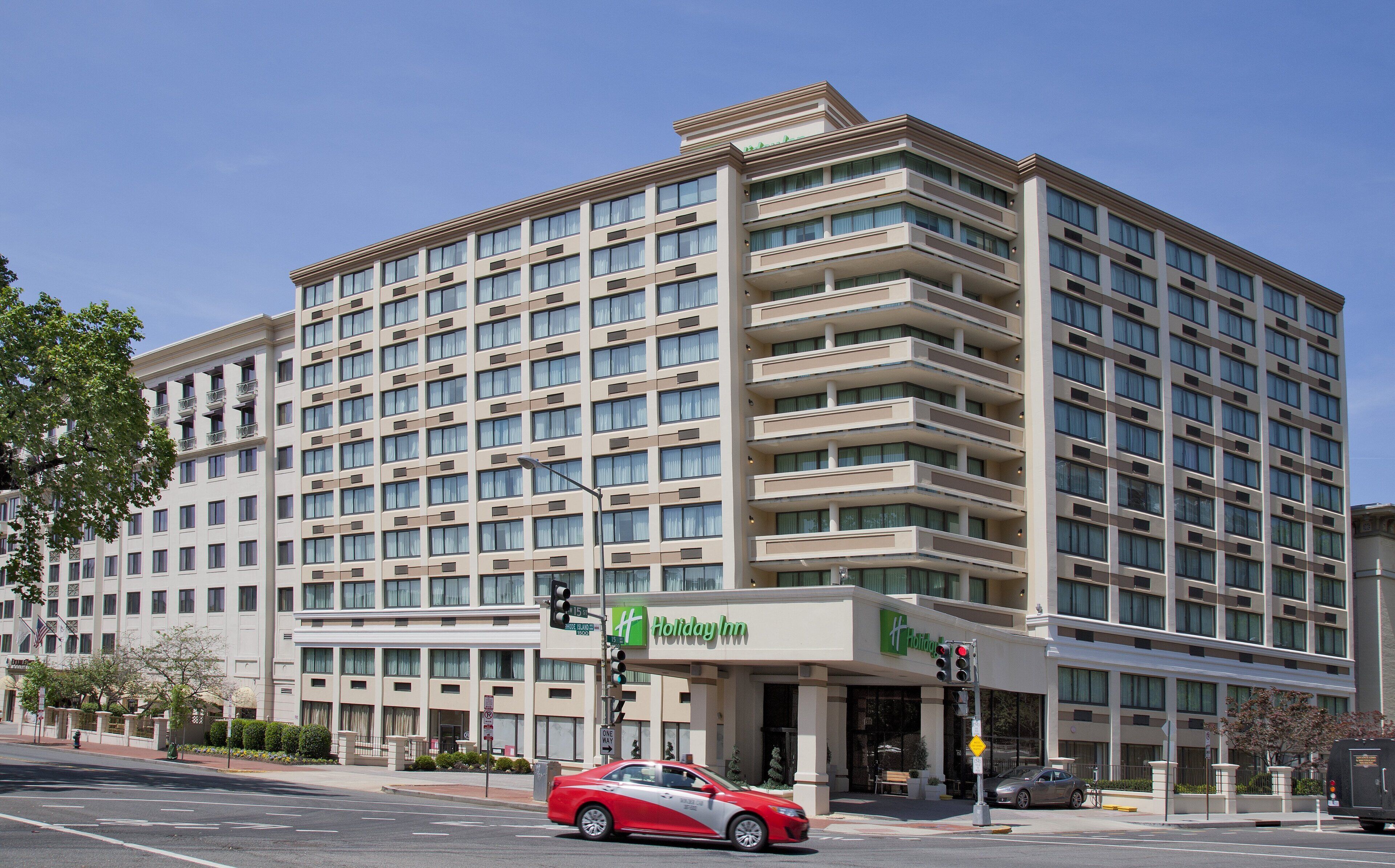 A multi-story hotel with a modern design, featuring a Holiday Inn sign.