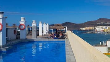 Outdoor pool, open 9:00 AM to 7:00 PM, pool umbrellas, pool loungers