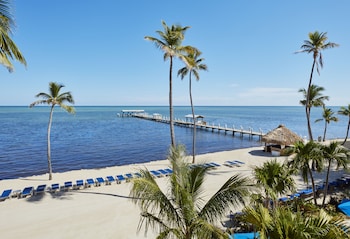 Private beach, sun loungers, beach umbrellas, beach towels at Cheeca Lodge & Spa