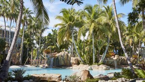 A tropical resort with a swimming pool, palm trees, and a waterfall. - Cheeca Lodge & Spa (Islamorada)