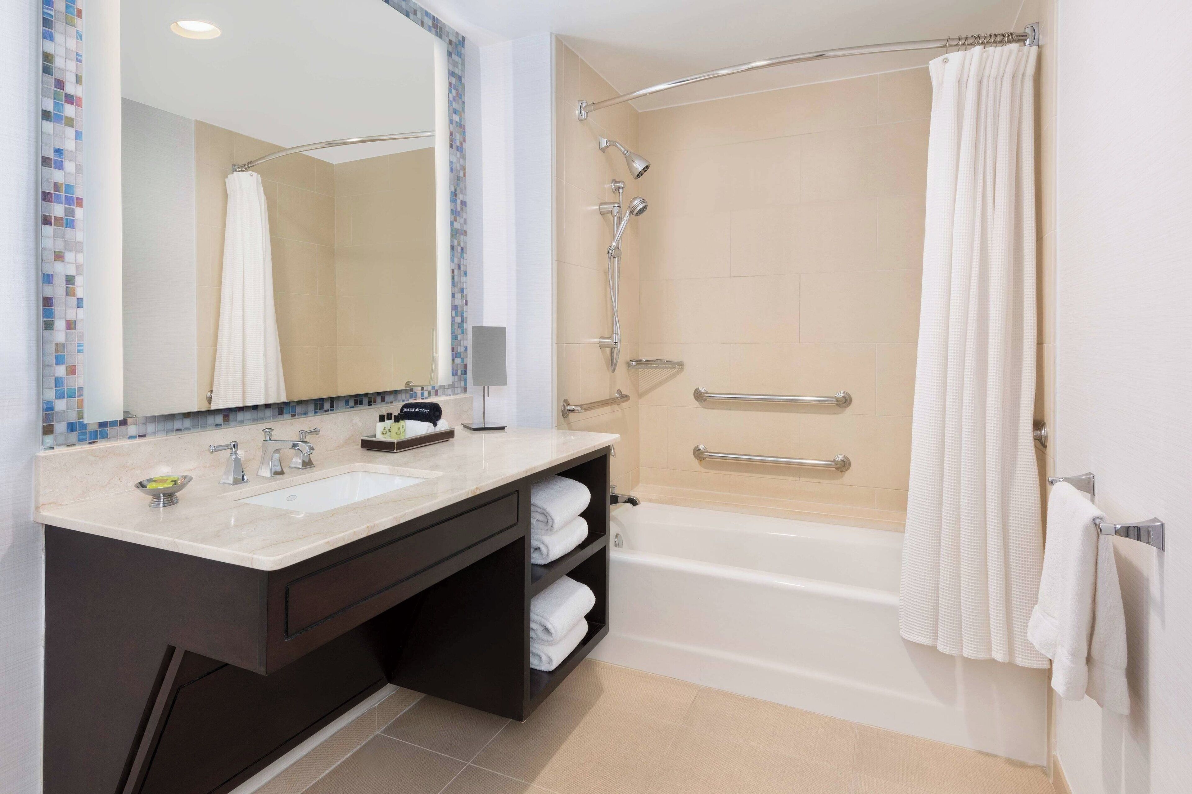 combined shower/bathtub, designer toiletries, hair dryer, bathrobes