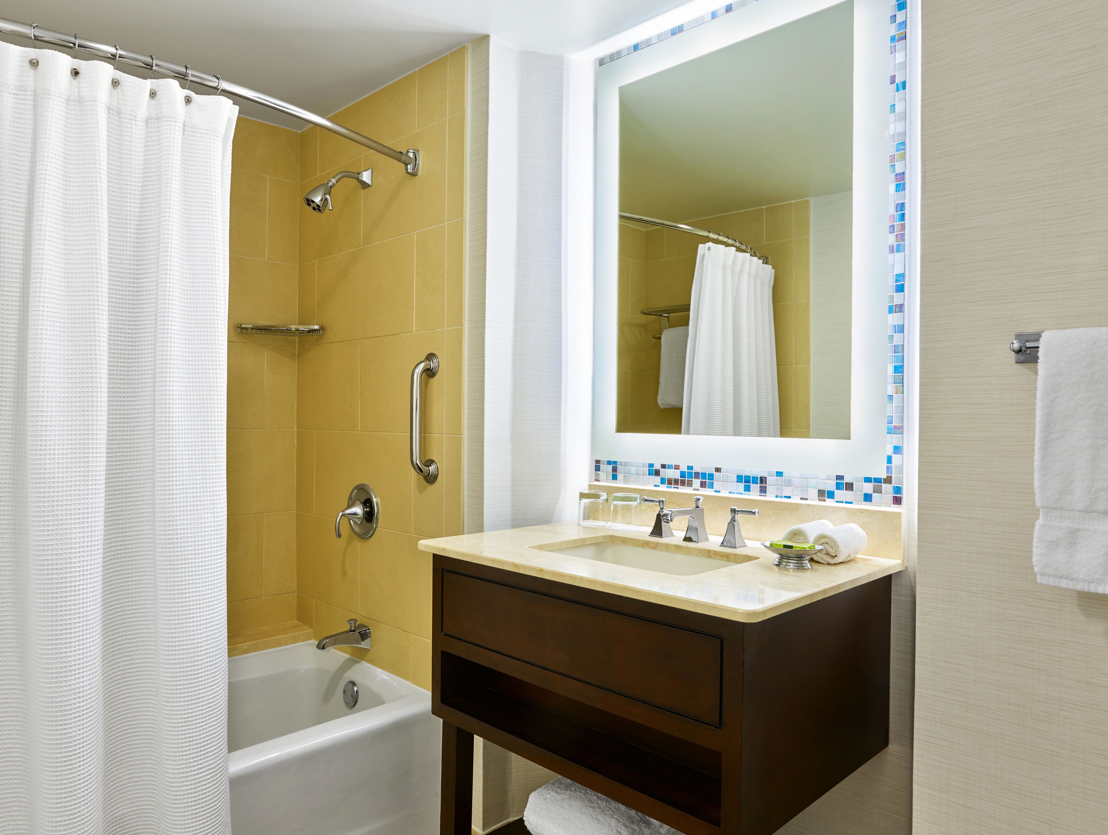 combined shower/bathtub, designer toiletries, hair dryer, bathrobes