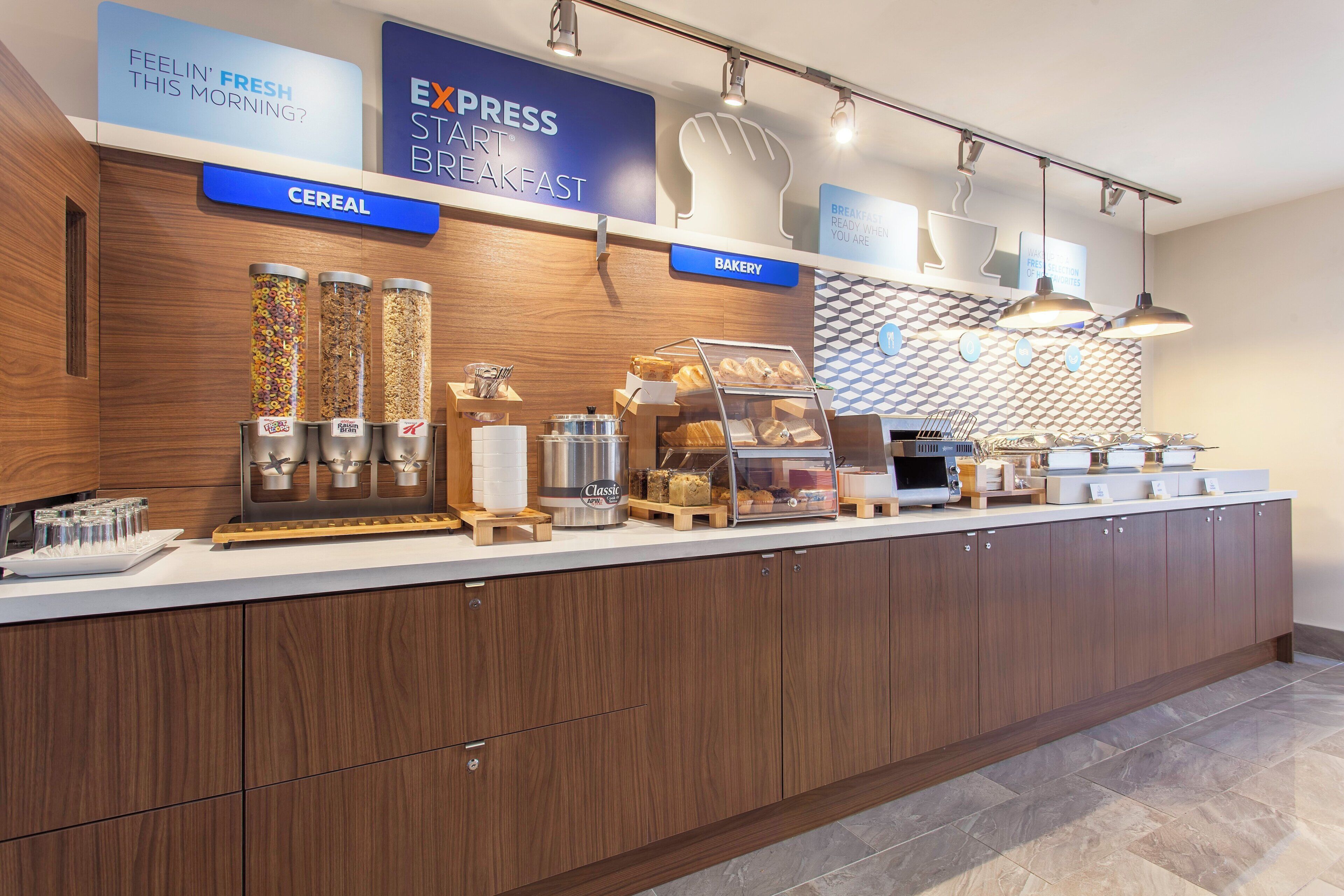 A breakfast buffet area with cereal, bakery, and express breakfast options.
