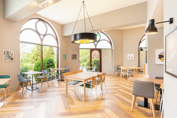 Enjoy meals in a bright and airy dining area with large windows and comfortable seating.