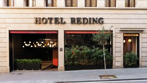 Hotel Reding with a modern facade, large windows, and a sign indicating 'chic&basic' on the right.