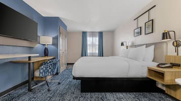 Premium bedding, desk, laptop workspace, blackout drapes