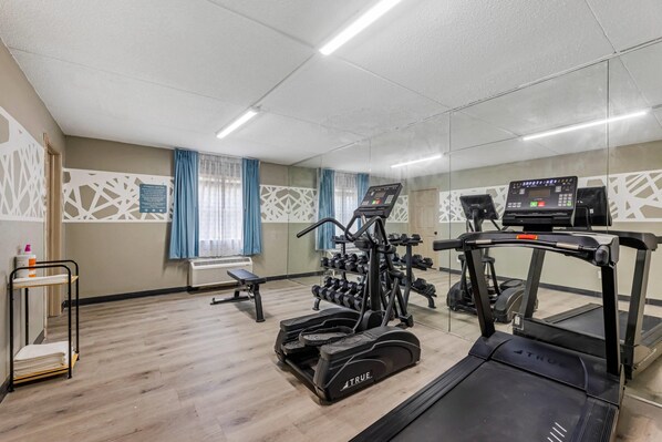 A gym with treadmills, a stationary bike, and a weight machine.