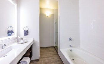 Combined shower/tub, rainfall showerhead, designer toiletries at Grand Bay Hotel San Francisco