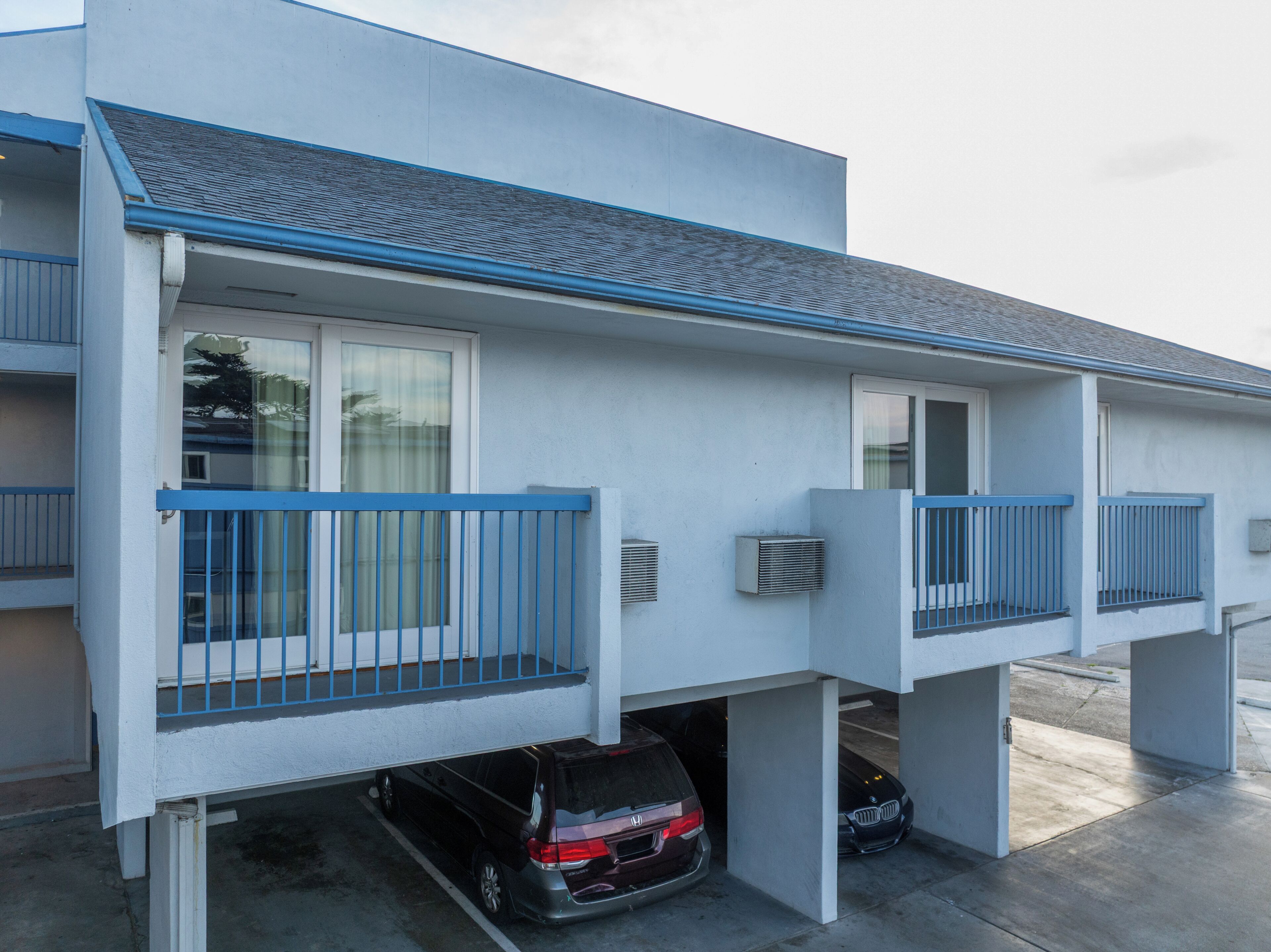 A two-story building with a garage parking area.