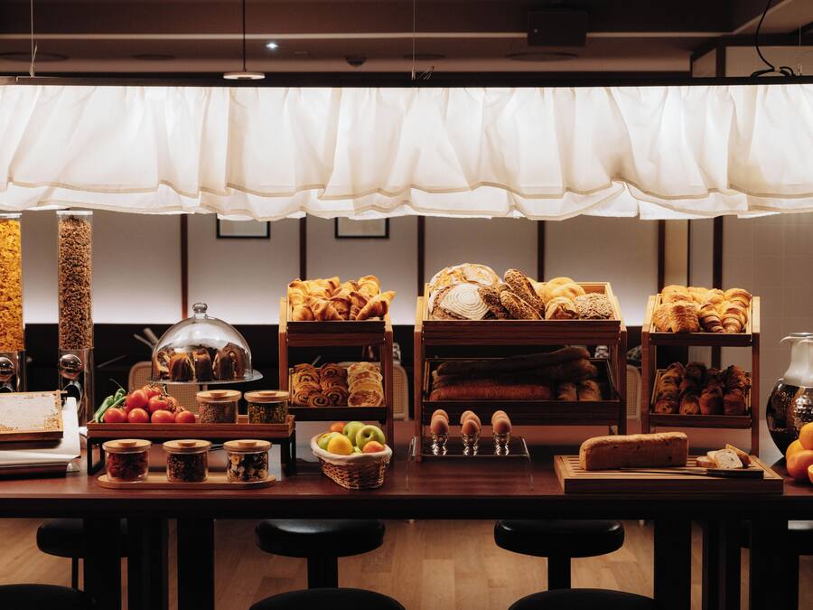 A bakery display with various baked goods and a decorative hanging light.