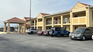 A multi-story motel with a parking lot.