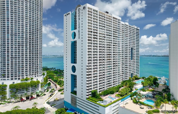 A high-rise hotel with a modern design, featuring a prominent 'DOUBLETREE' sign, multiple balconies, and a view of the ocean. - DoubleTree by Hilton Grand Hotel Biscayne Bay (Miami)