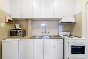 Standard One Bedroom Apartment | Private kitchen | Coffee/tea maker