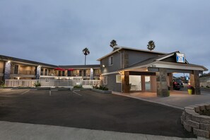 Experience the hotel's sleek design, featuring a flat roof and covered parking area, with easy access to the entrance via a covered walkway.