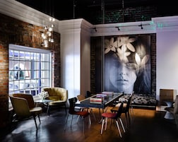 A modern interior with a brick wall, a large window, and a mural.