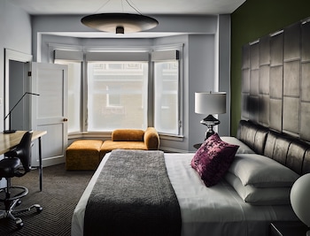 Deluxe Suite, 1 Bedroom | In-room safe, desk, blackout drapes, iron/ironing board at Hotel Zeppelin San Francisco