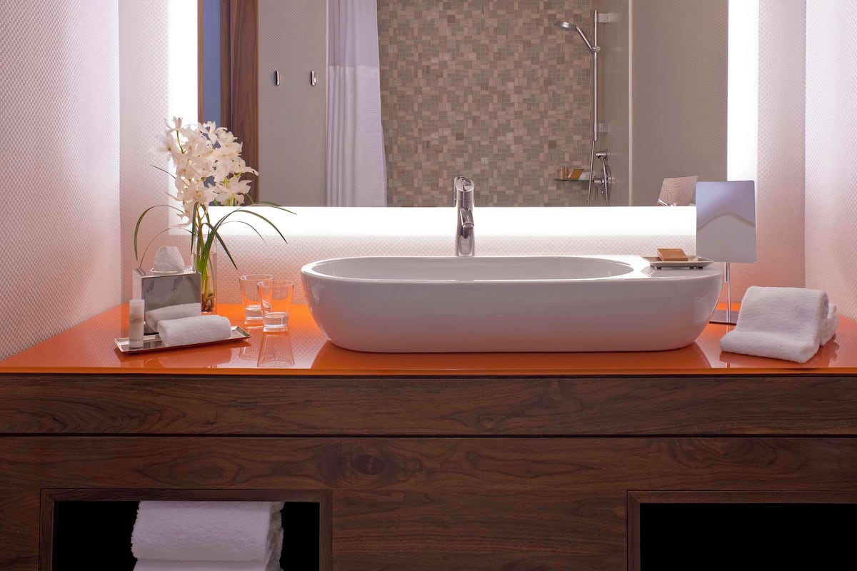 designer toiletries, hair dryer, towels, soap