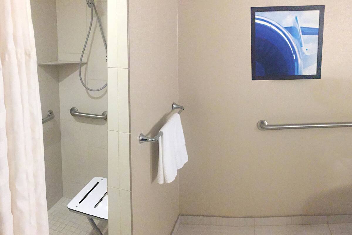 combined shower/bathtub, designer toiletries, hair dryer, towels