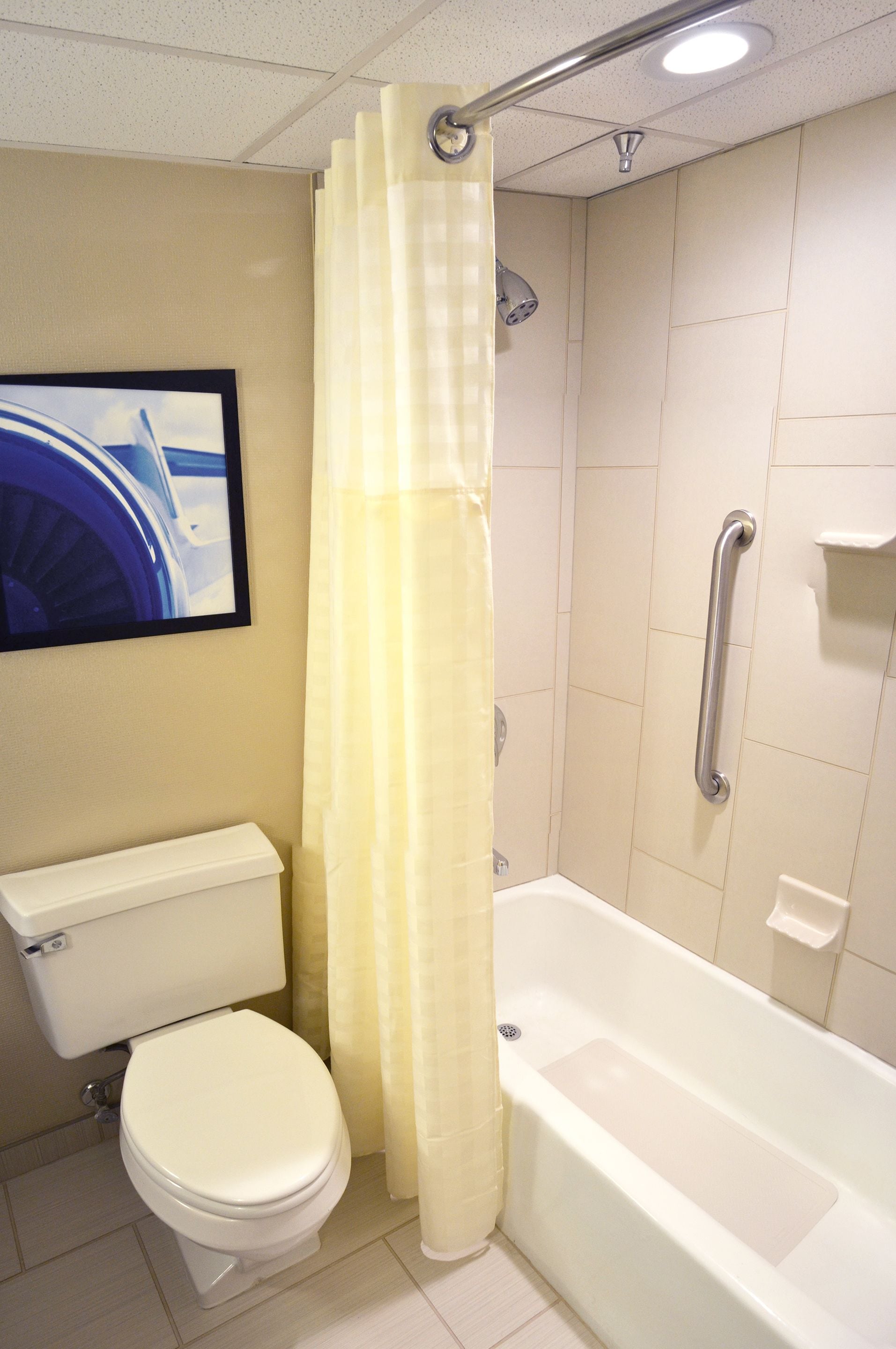 combined shower/bathtub, designer toiletries, hair dryer, towels