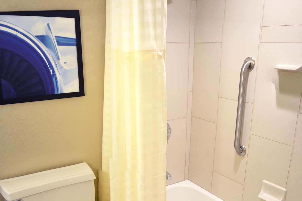 combined shower/bathtub, designer toiletries, hair dryer, towels