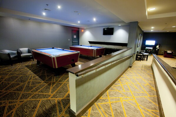 Enjoy a game of pool or cards in this cozy space with two pool tables, comfortable seating, and a large flat-screen TV.