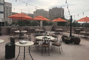 Relax in our outdoor seating area, surrounded by lush greenery and equipped with a projector for presentations or events.