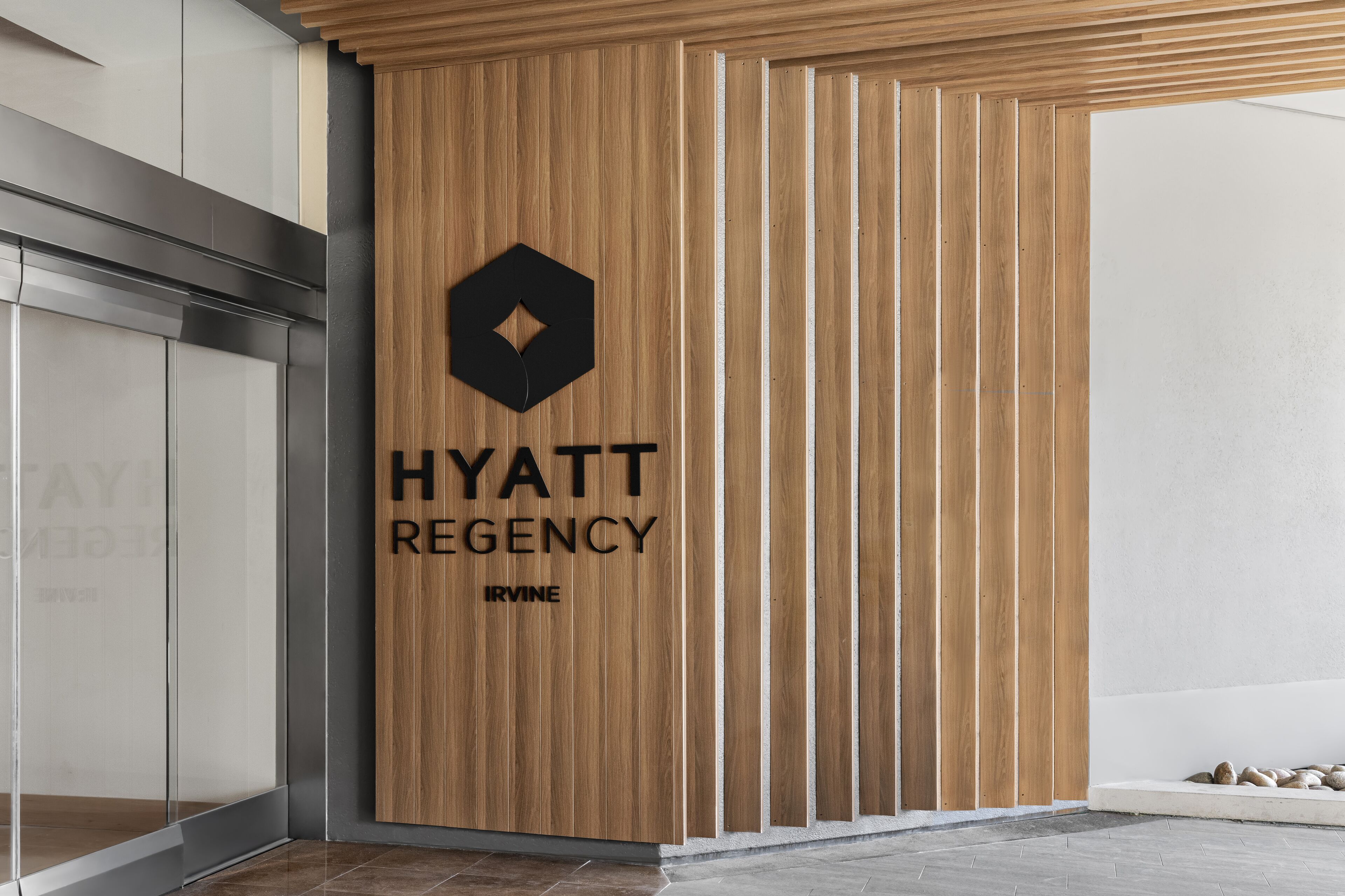 A wooden wall with the text "HYATT REGENCY IRVINE" and a logo.