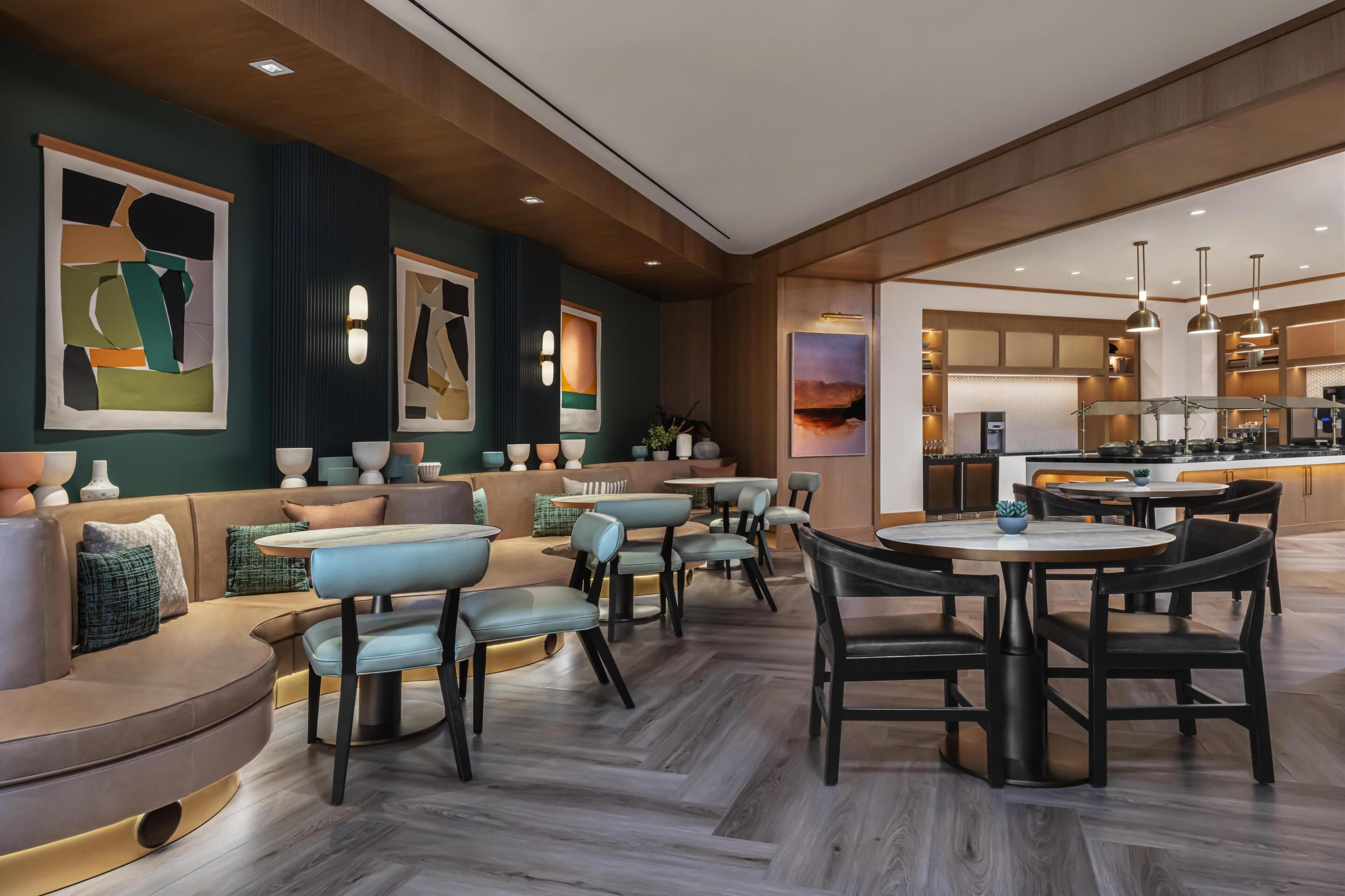 A modern interior with a seating area, a kitchen, and a dining space.