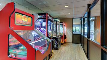 Play a variety of games at the arcade, featuring STUFF and HOT STUFF machines in individual booths.