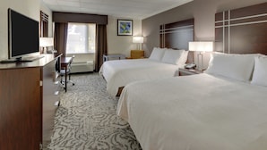 A hotel room with two beds, a desk, a TV, and a window with curtains. - Holiday Inn Express Aberdeen by IHG (Aberdeen)
