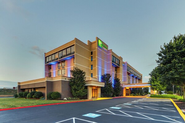 A Holiday Inn Express hotel with a parking lot and a landscaped area.
