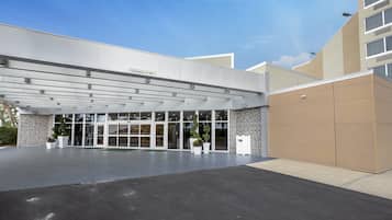 A modern building entrance with a clear sign indicating a clearance of 11'-00'.
