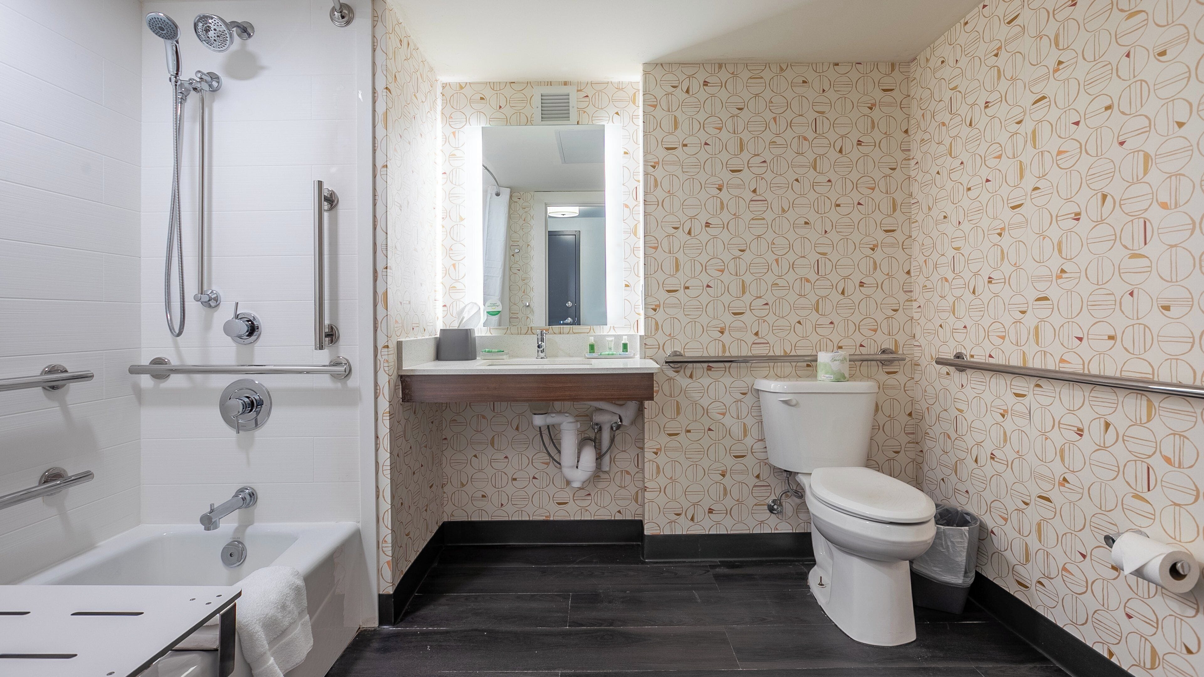 A bathroom with a bathtub, toilet, and shower.