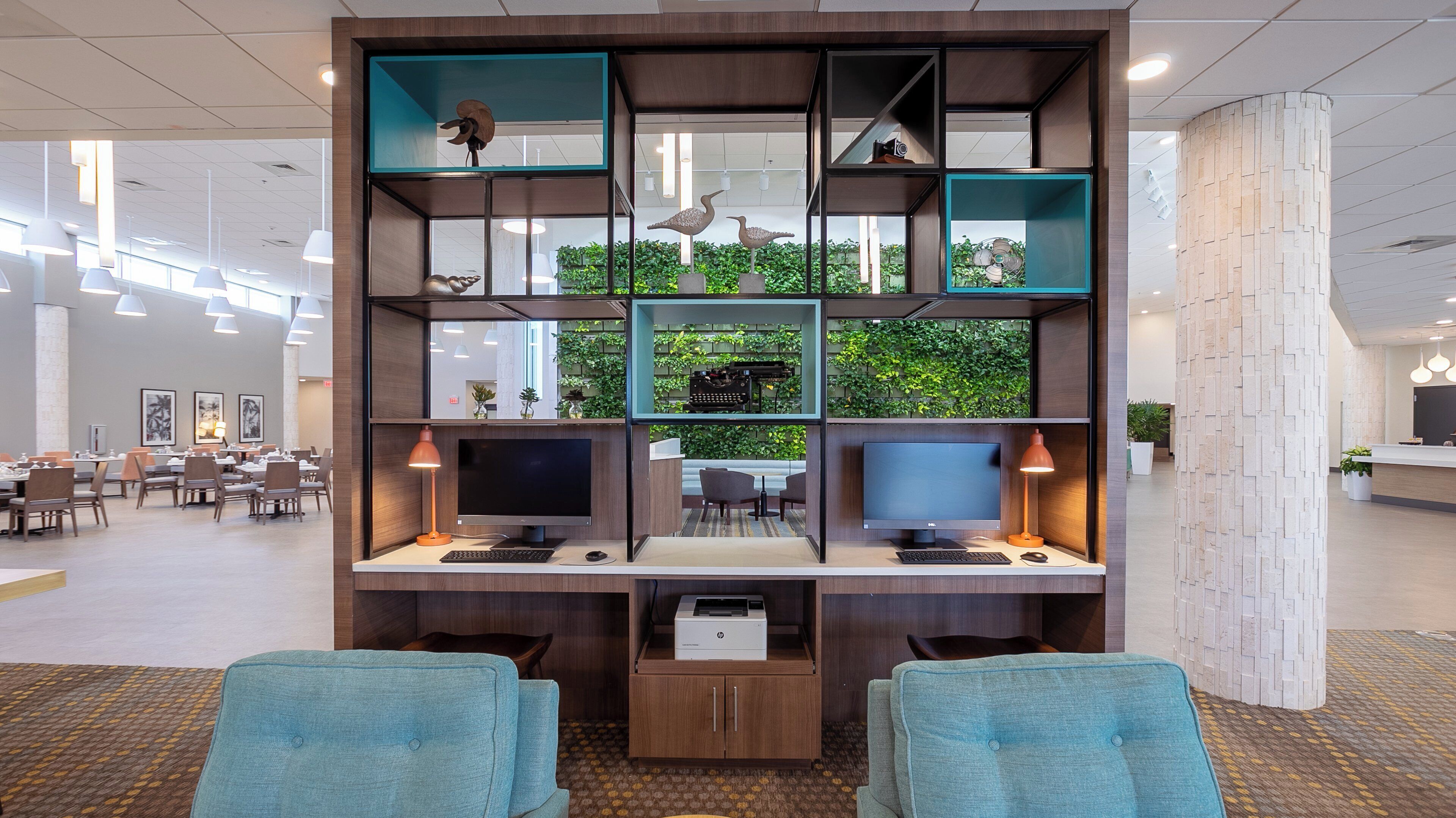 A modern office space with desks, computers, and seating areas.
