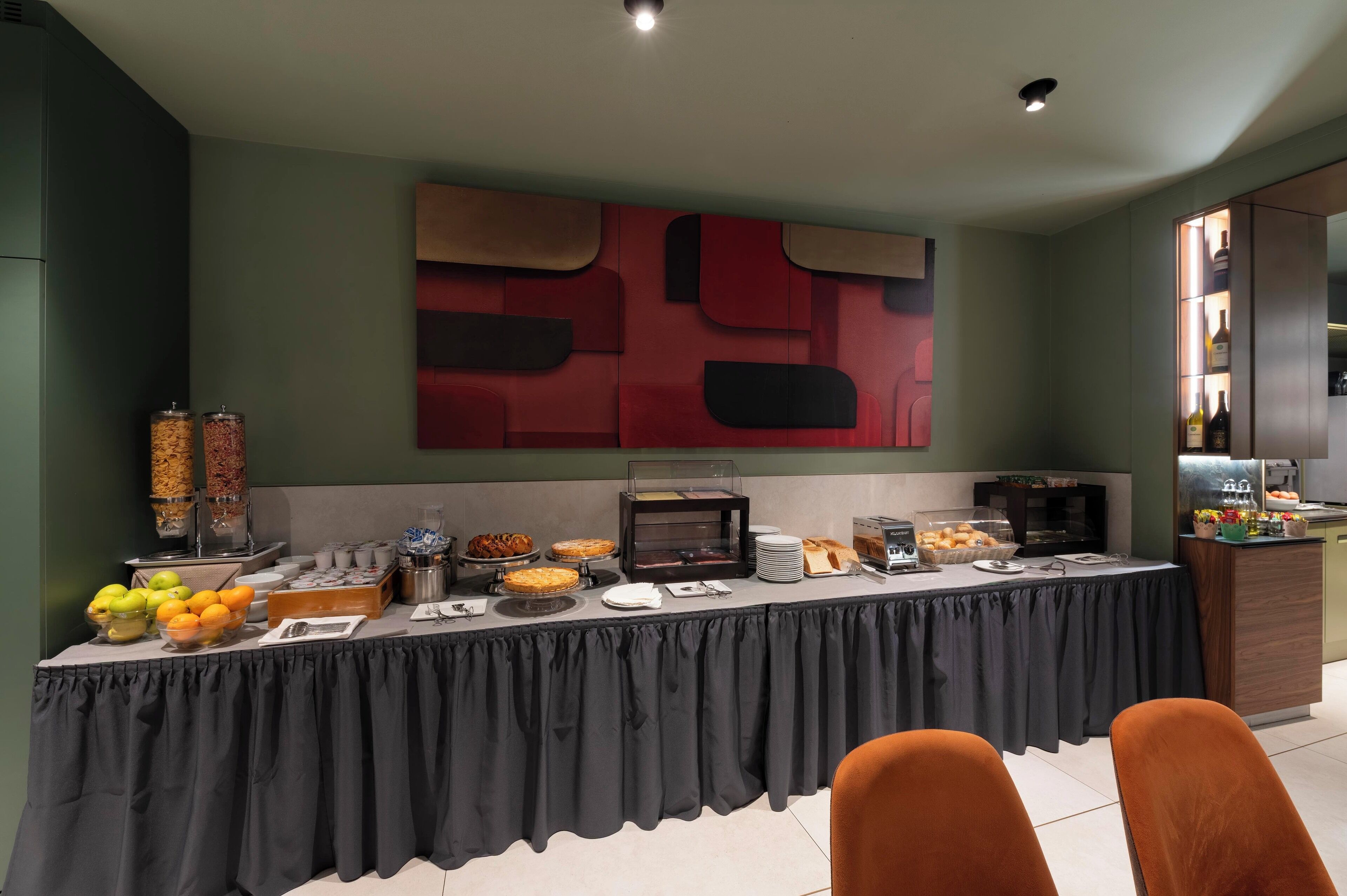 A buffet setup with various food items and a coffee station.