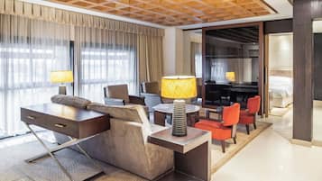 Club Suite, 1 King Bed | Living room | 40-inch LED TV with cable channels, TV