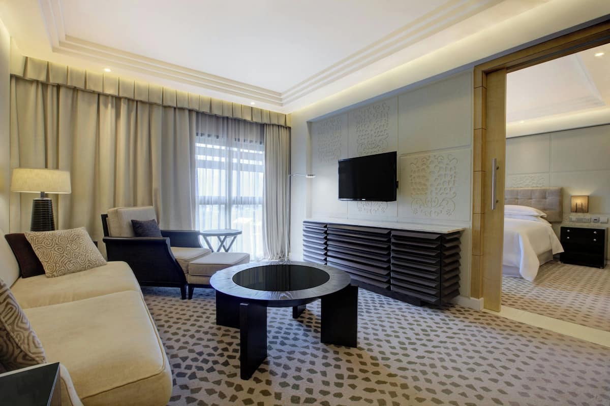 Junior Suite, 1 King Bed | Living room | 40-inch LED TV with cable channels, TV
