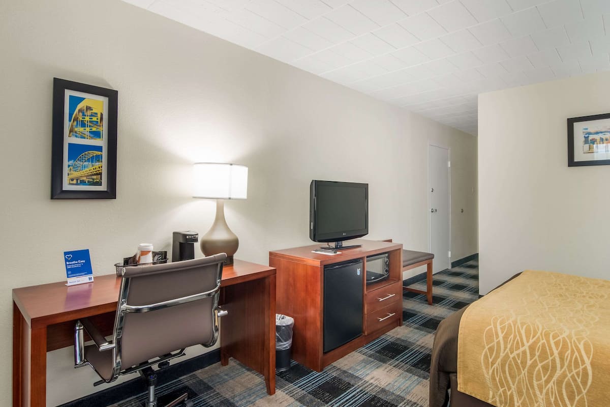 Premium bedding, desk, laptop workspace, blackout drapes