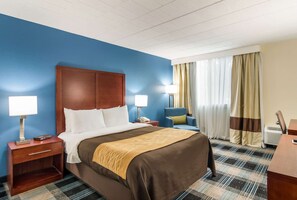 Premium bedding, desk, laptop workspace, blackout drapes