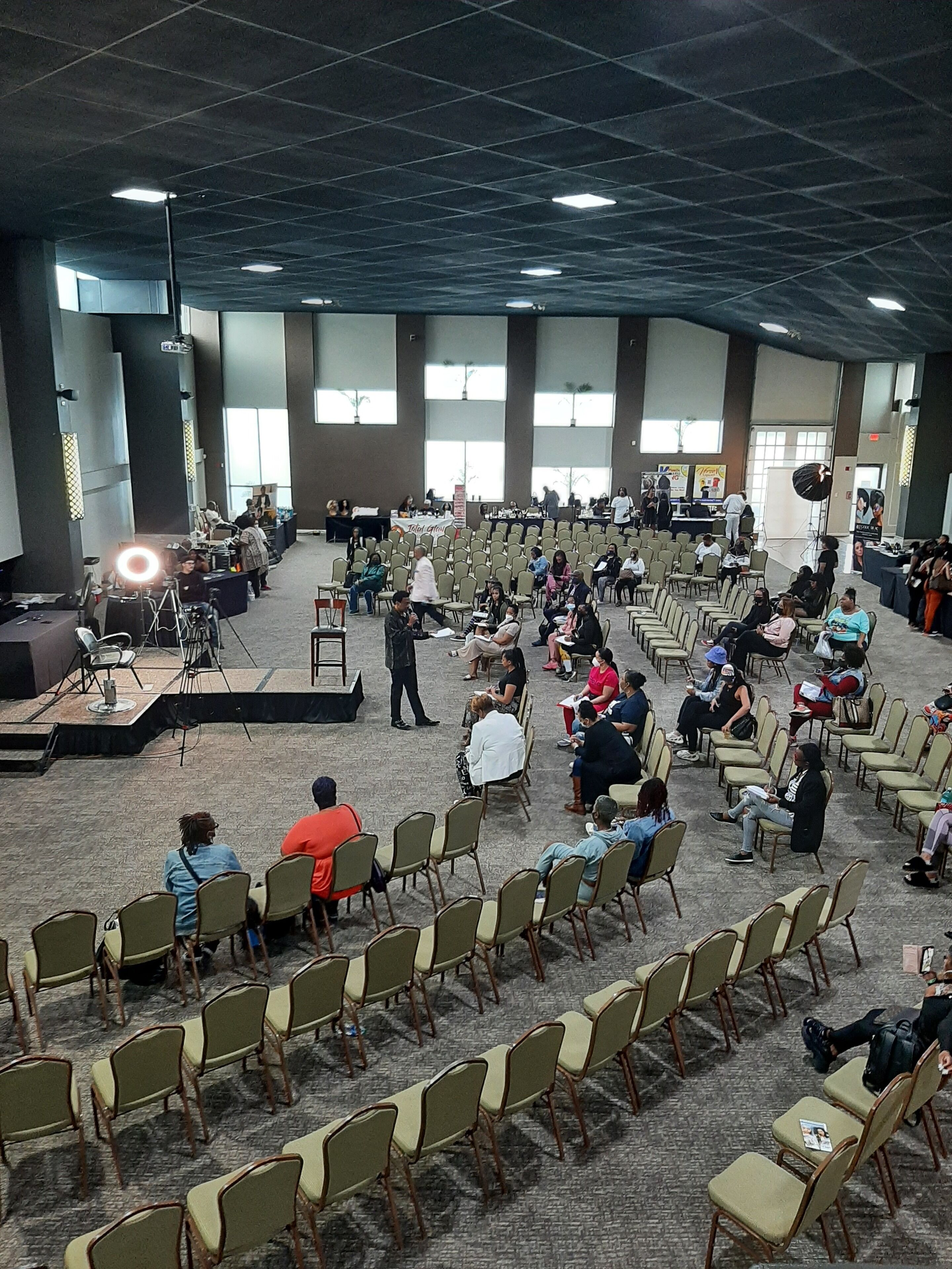 A large hall with rows of chairs and a stage at the front.