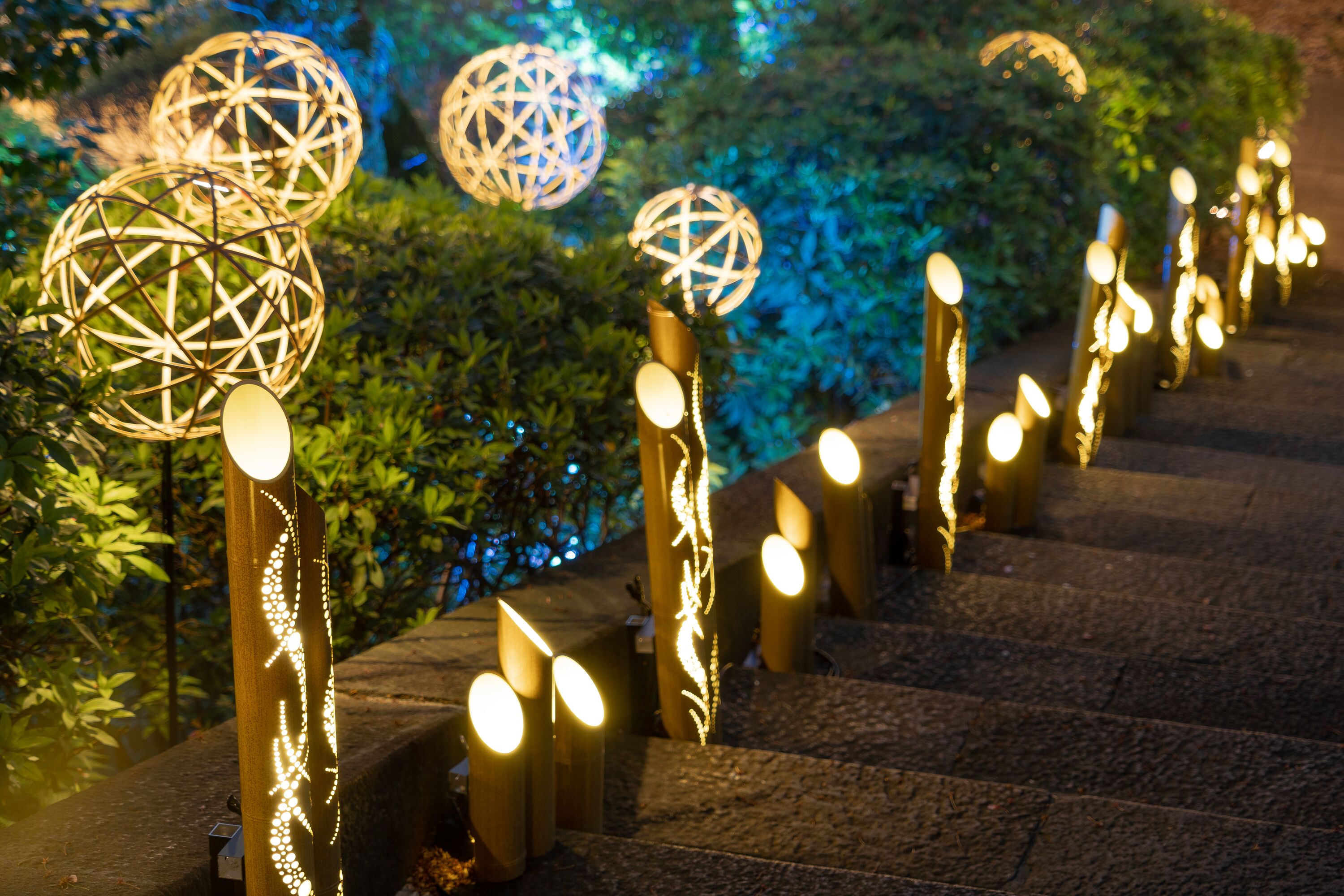 A staircase with decorative spherical lights and a wooden handrail.