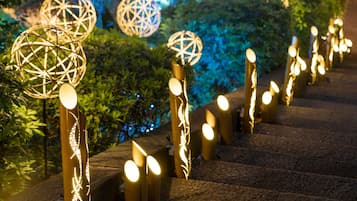 A staircase with decorative spherical lights and a wooden handrail.