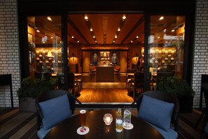 An interior view of a restaurant with a bar area, wooden flooring, and seating arrangements. - Grand Prince Hotel Shin Takanawa (Tokyo)