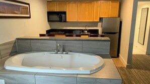 A modern bathroom with a freestanding bathtub, a sink, and a shower area.