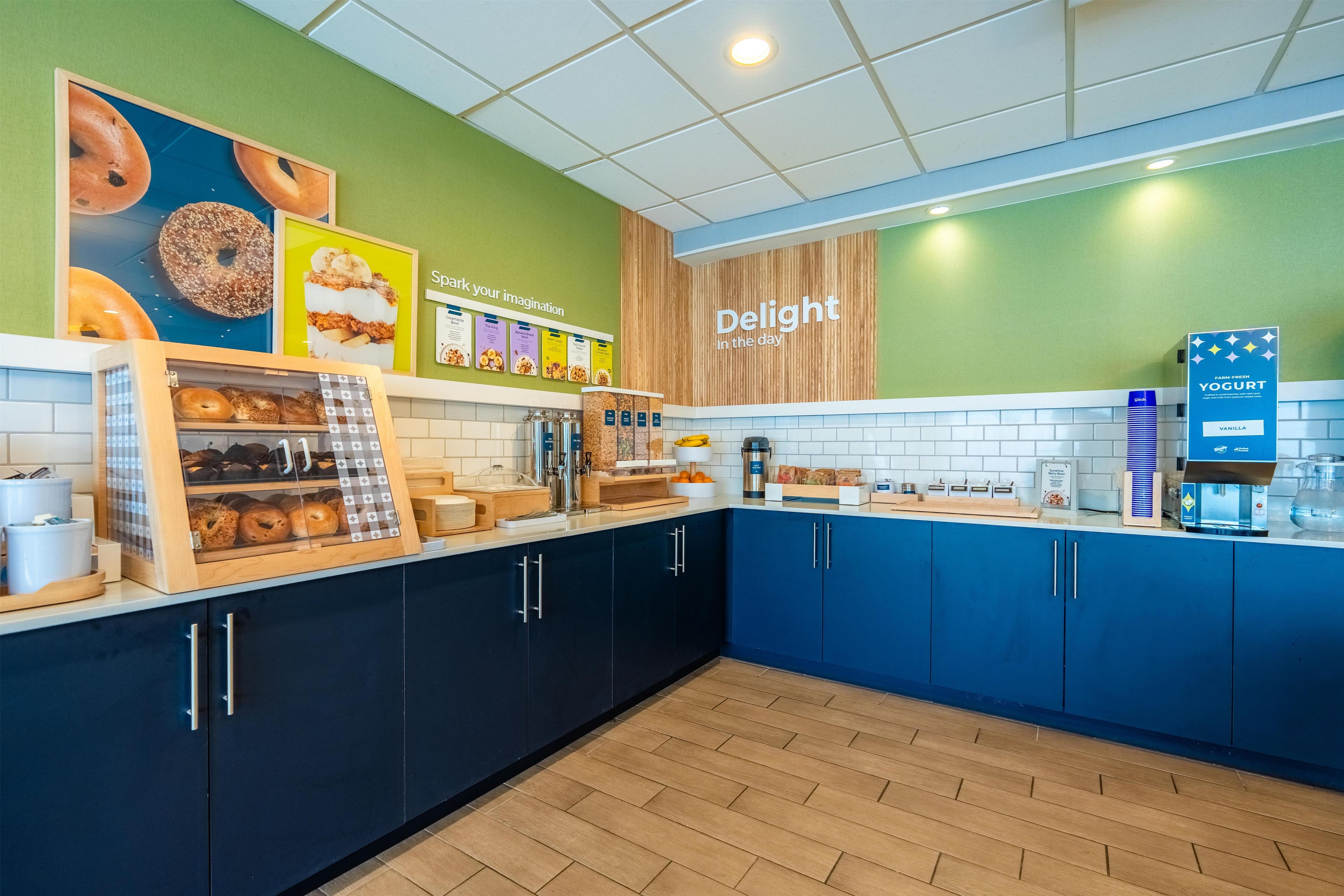 A bakery section with various baked goods on display, a coffee machine, and a sign for farm-fresh yogurt.