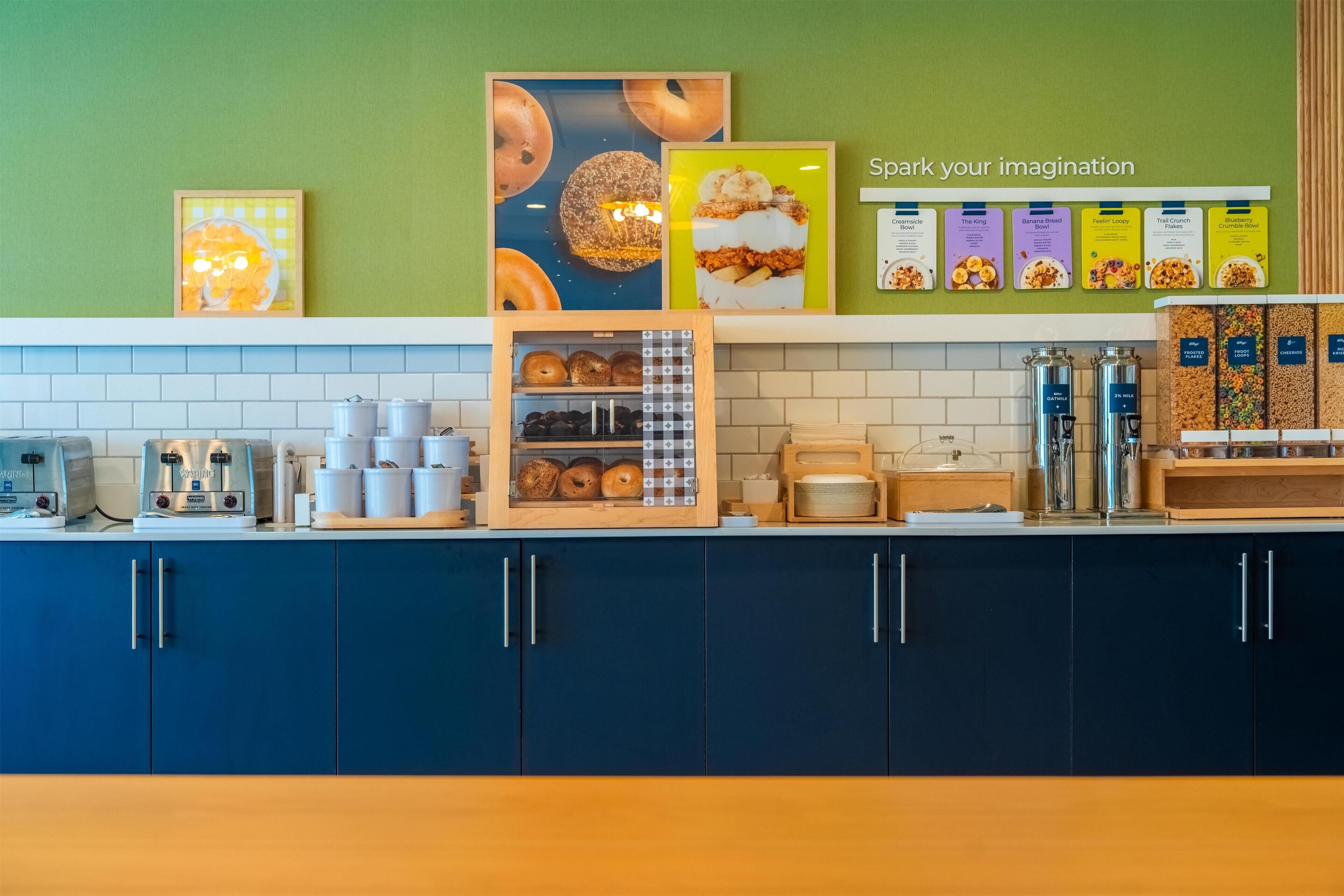 A kitchen counter with various food items and appliances, including a coffee machine, a toaster, and a display of packaged snacks.